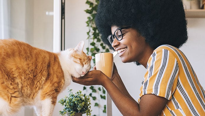 Woman petting her cat Woman petting her cat